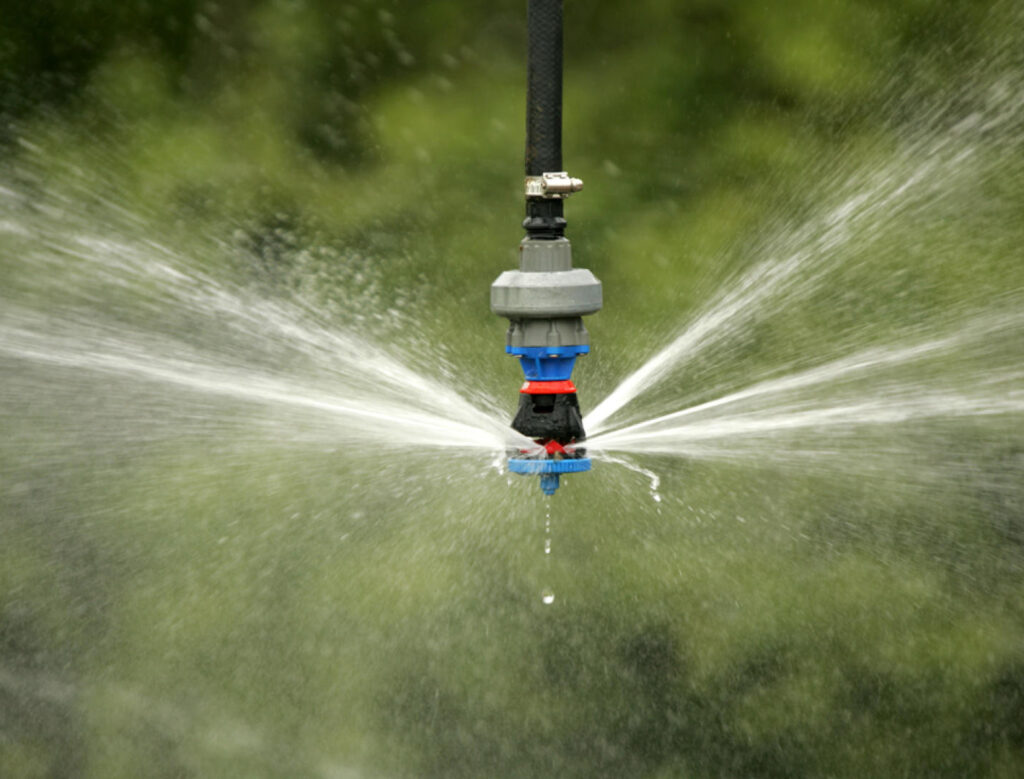 Irrigation sprinkler with water spraying out